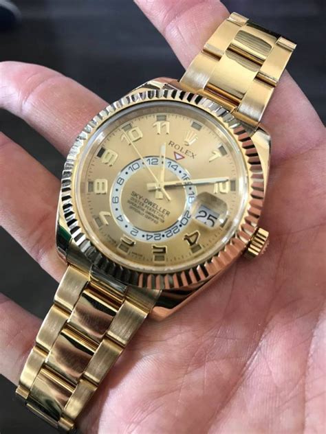 rolex skydweller gold on tattoo arm